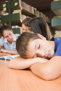 A school boy not interested in reading