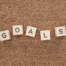 top view of 'goals' word made of wooden blocks on wooden tabletop, goal setting concept