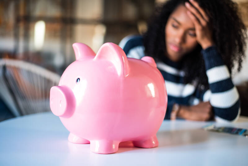 sad-frustrated-black-woman-with-piggy-bank