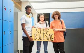 a group of students with stop bullying sign
