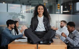 woman sitting on desk showing work life balance